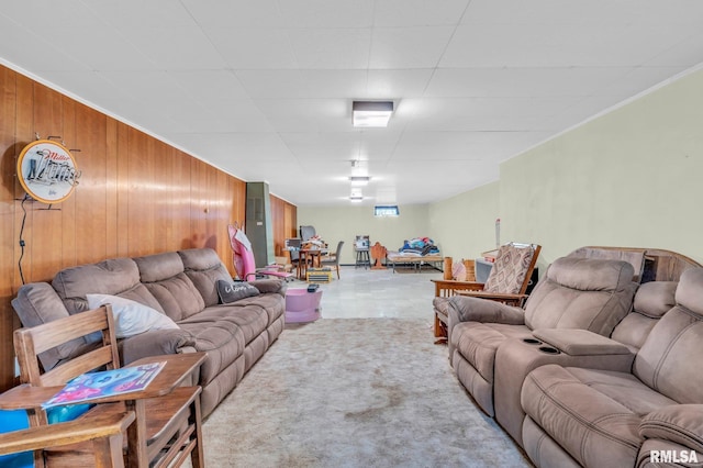 carpeted living room with wood walls