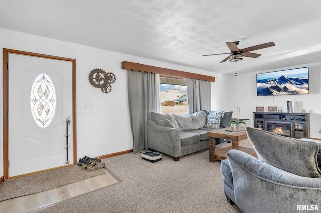 carpeted living room with ceiling fan