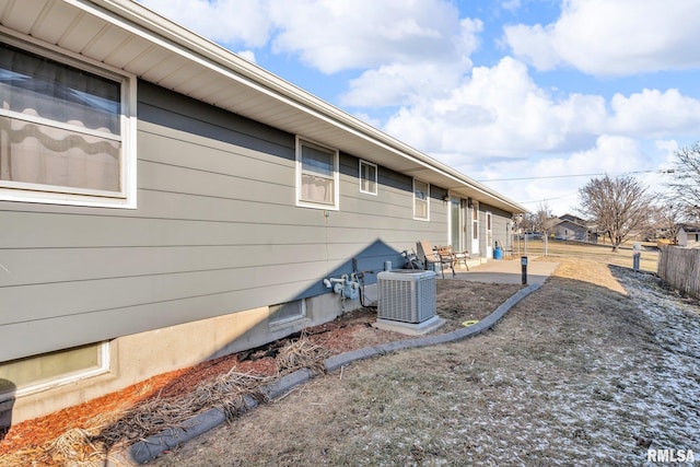 view of side of home with a patio and central AC