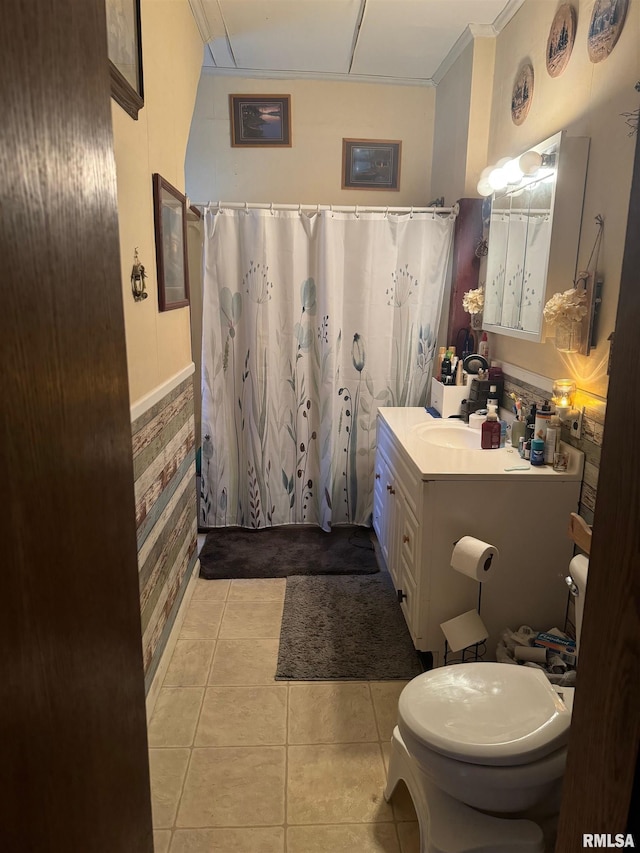 bathroom featuring toilet, vanity, tile patterned floors, crown molding, and curtained shower