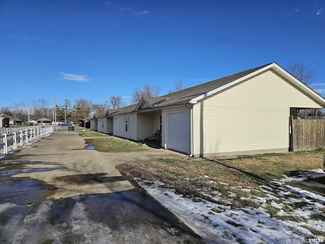 snow covered property featuring a garage