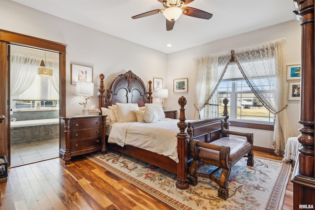 bedroom featuring ceiling fan, connected bathroom, and hardwood / wood-style floors