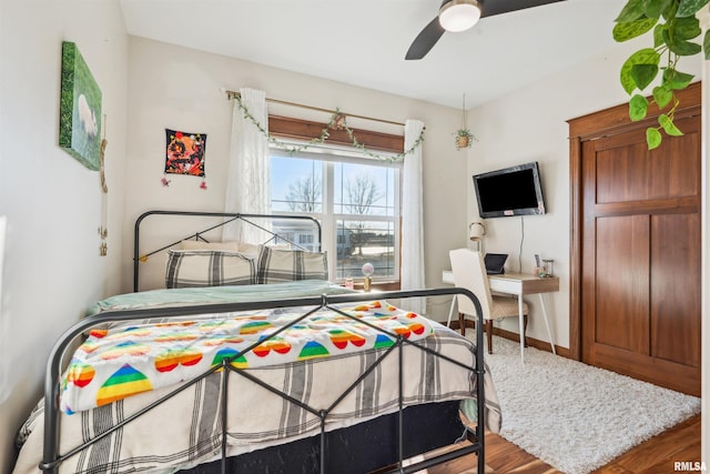 bedroom with ceiling fan and hardwood / wood-style flooring