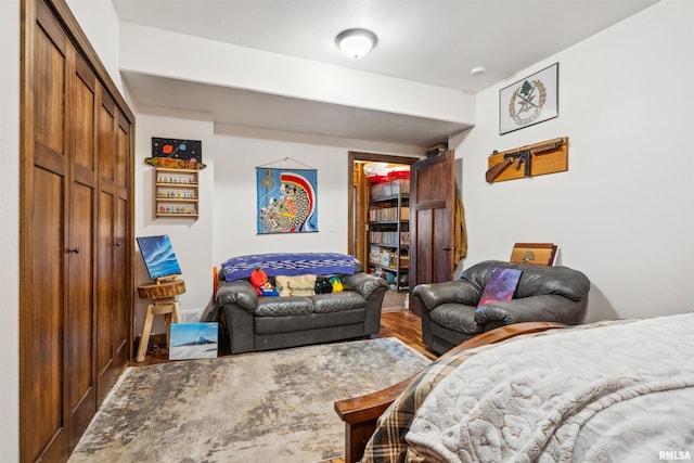 bedroom with wood-type flooring and a closet