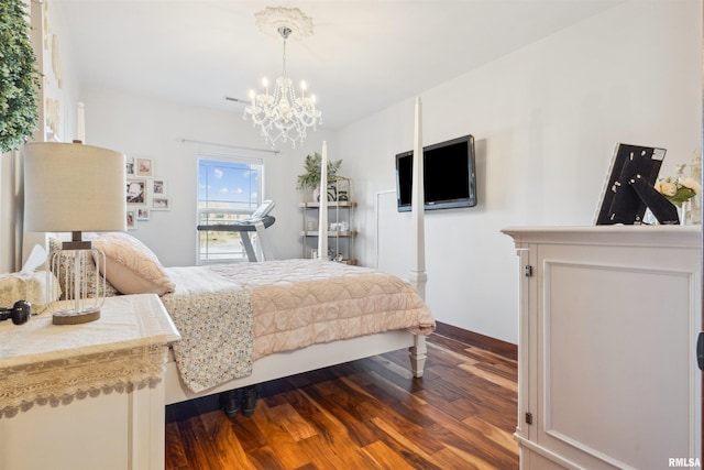 bedroom with a notable chandelier and hardwood / wood-style floors