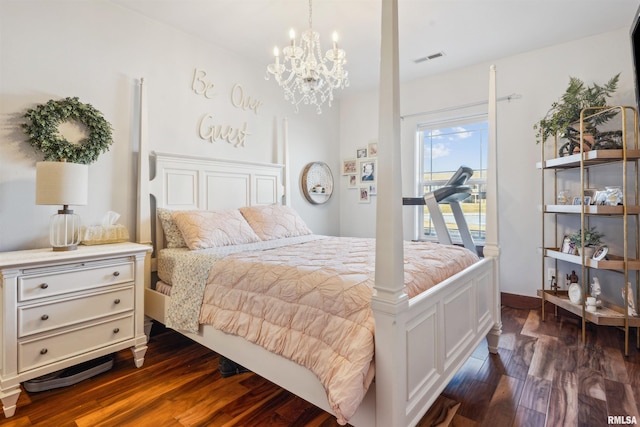 bedroom featuring dark hardwood / wood-style flooring and a chandelier