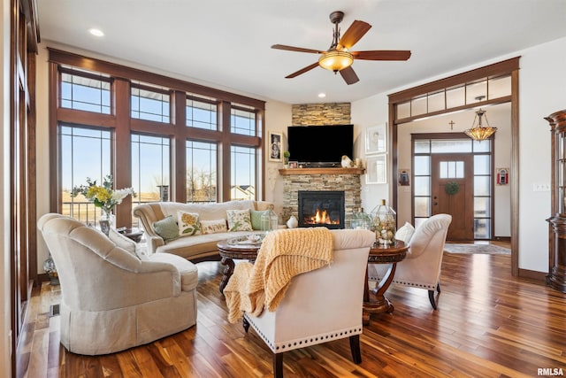 living room with dark wood-type flooring, a healthy amount of sunlight, and ceiling fan