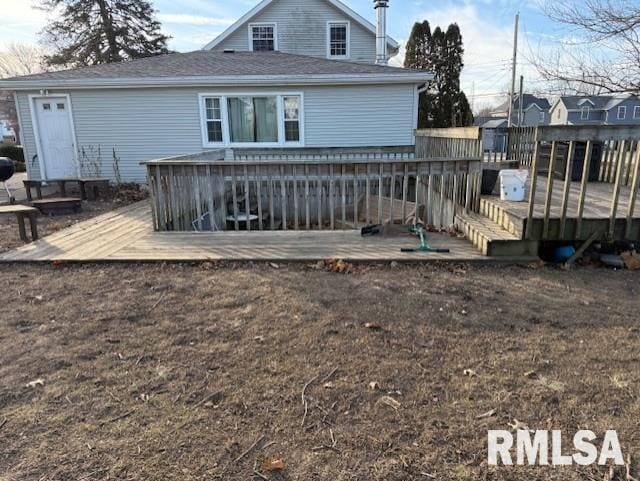 back of property featuring a wooden deck