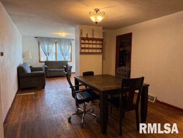 dining space with dark hardwood / wood-style flooring