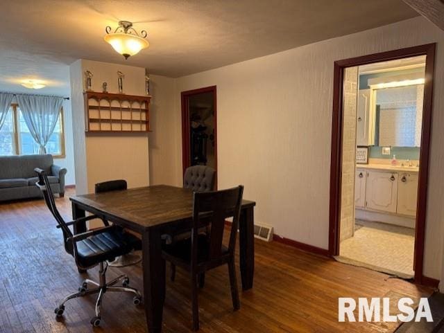 dining area with hardwood / wood-style flooring