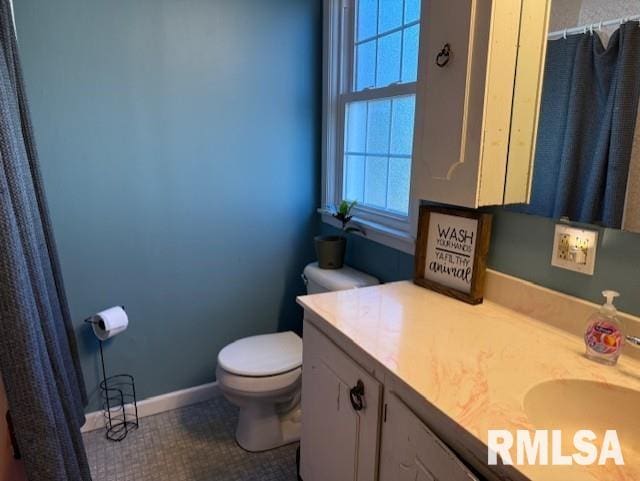 bathroom featuring toilet, tile patterned floors, and vanity