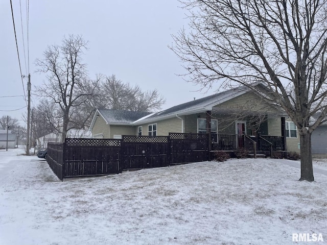 view of snow covered back of property