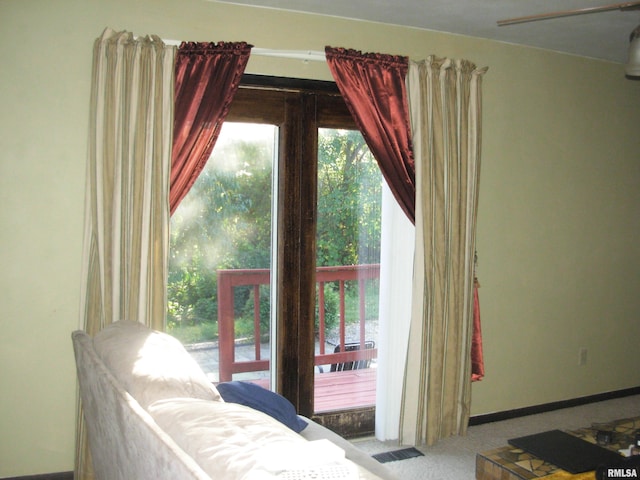 bedroom featuring light colored carpet and multiple windows