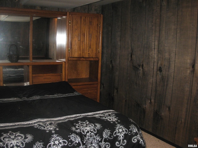 bedroom featuring wood walls