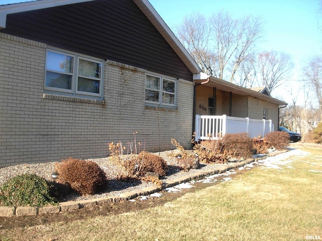 view of property exterior with a yard and covered porch