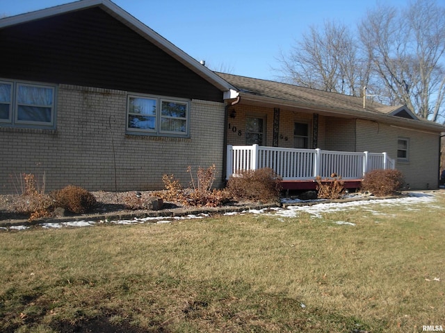 exterior space with a porch and a lawn