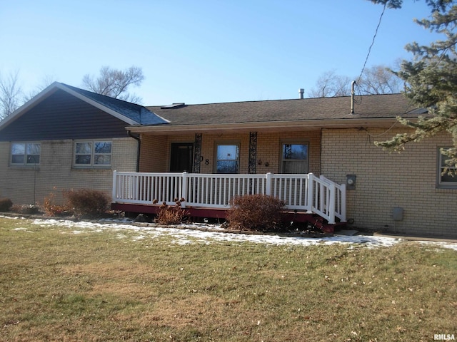 single story home featuring covered porch and a front lawn