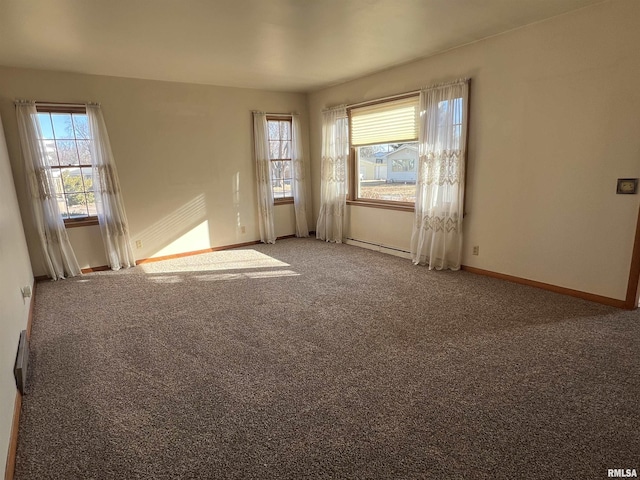 carpeted spare room with baseboard heating