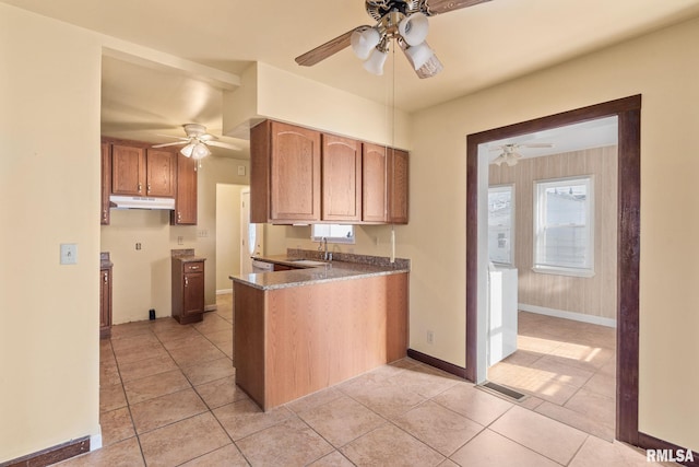 kitchen featuring ceiling fan, light tile patterned floors, and sink