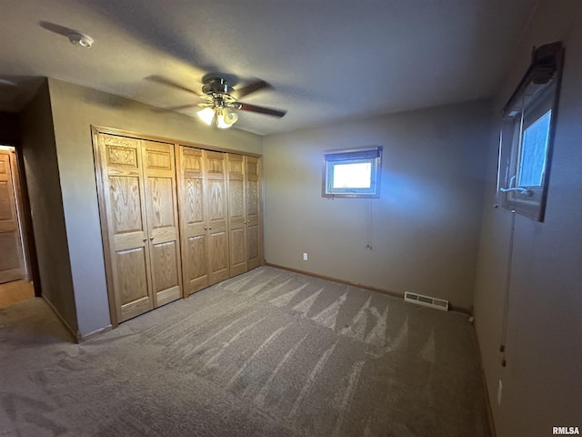 unfurnished bedroom with ceiling fan and carpet flooring