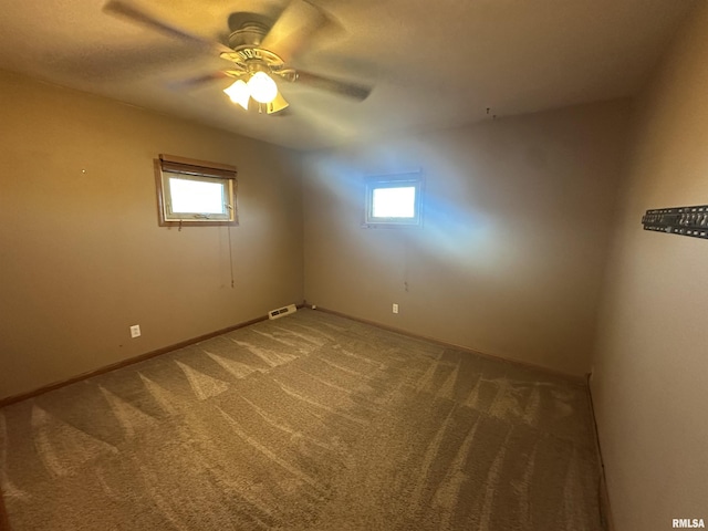 carpeted empty room with ceiling fan and a healthy amount of sunlight