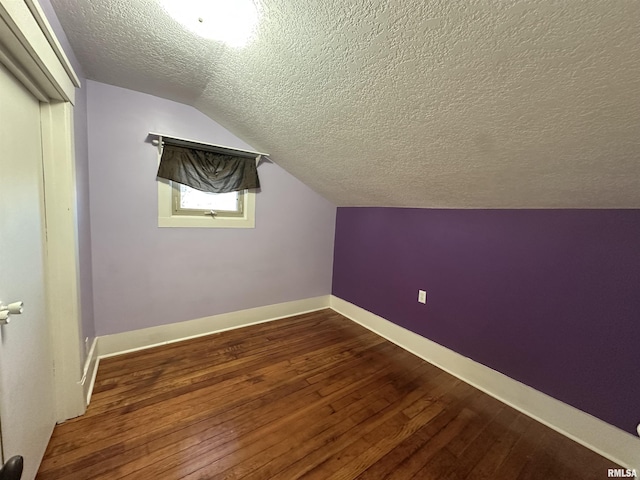 bonus room with a textured ceiling, lofted ceiling, and wood-type flooring