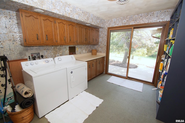 laundry area featuring independent washer and dryer and cabinets