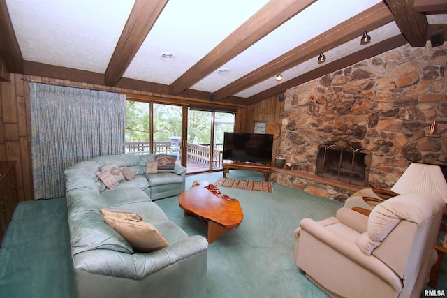 living room with a stone fireplace, beamed ceiling, and wood walls