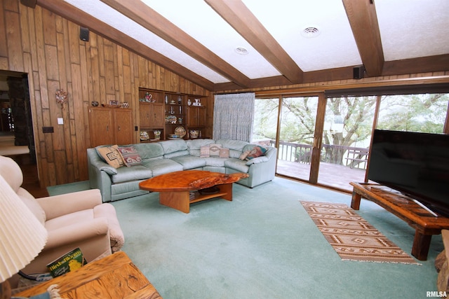 carpeted living room featuring vaulted ceiling with beams and wooden walls