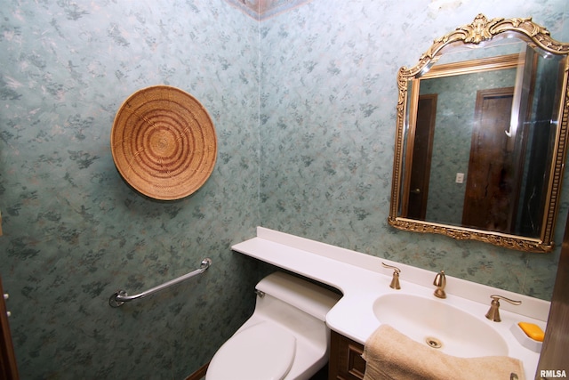 bathroom featuring toilet and vanity