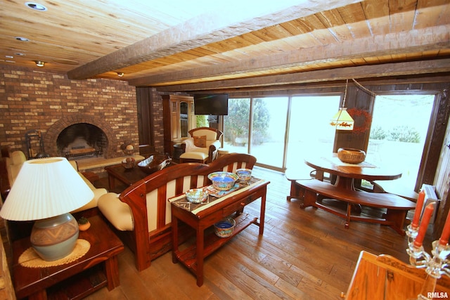 living room with hardwood / wood-style floors, a fireplace, beamed ceiling, and wooden ceiling