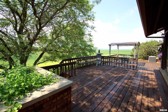 wooden deck featuring a pergola and cooling unit