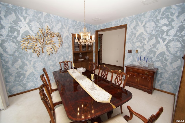 dining space with light carpet and a notable chandelier