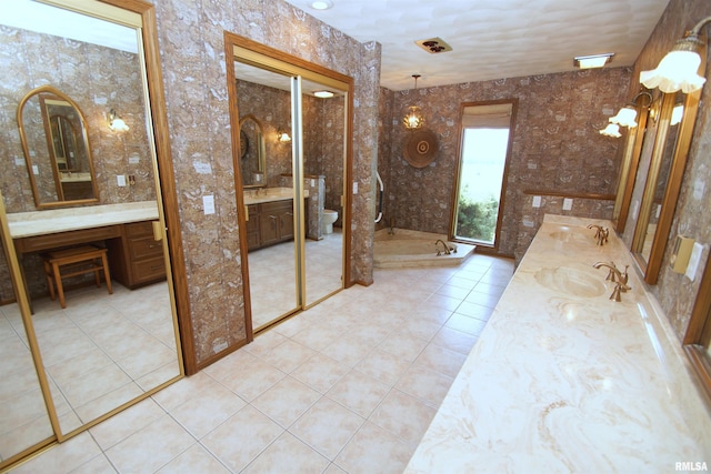 bathroom with toilet, tile patterned floors, and vanity