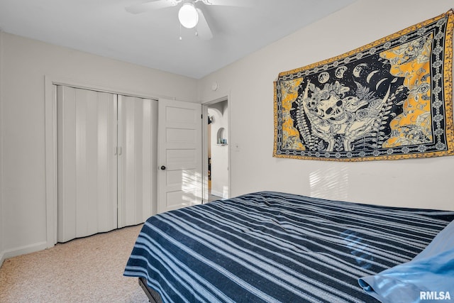 carpeted bedroom featuring a closet and ceiling fan