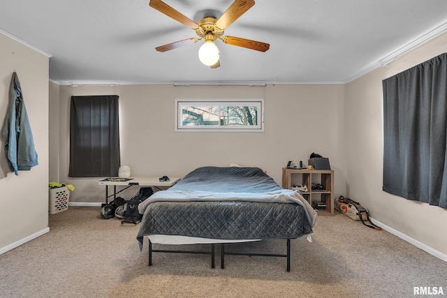 carpeted bedroom with ceiling fan and crown molding