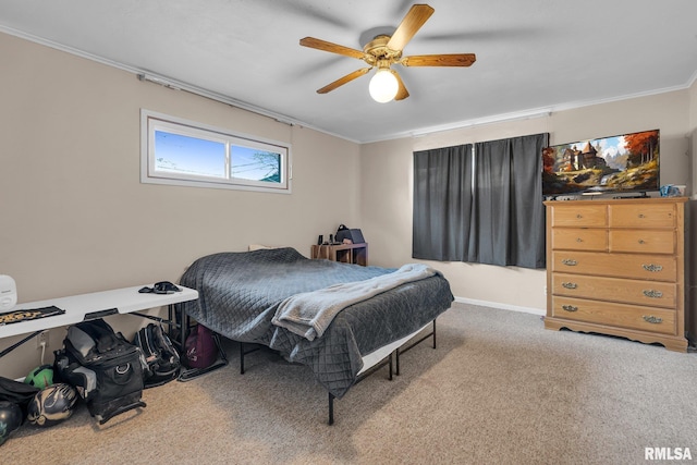 carpeted bedroom featuring ceiling fan and ornamental molding