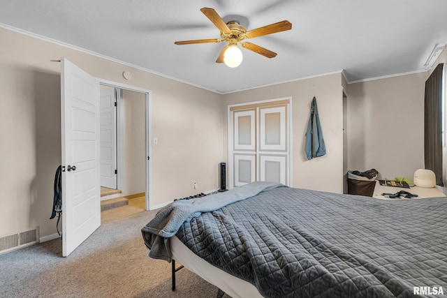 bedroom featuring ceiling fan, ornamental molding, and carpet flooring