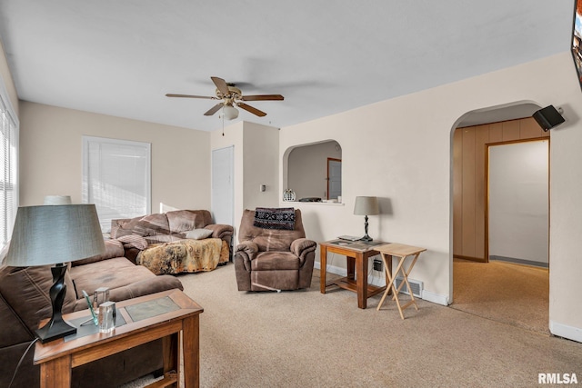 carpeted living room with ceiling fan