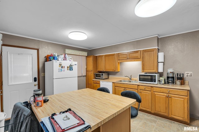 kitchen featuring crown molding, sink, wooden counters, and white appliances