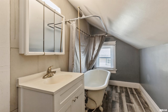 bathroom with hardwood / wood-style floors, vanity, separate shower and tub, and vaulted ceiling