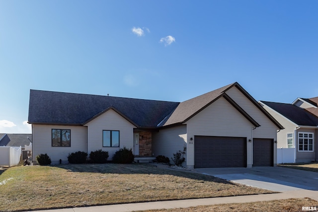 view of front of house featuring central AC unit, a garage, and a front lawn