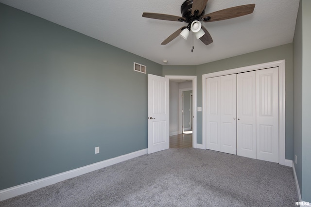 unfurnished bedroom featuring a closet, ceiling fan, and carpet flooring