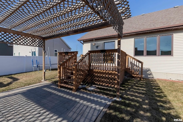 wooden terrace featuring a yard, a patio area, and a pergola