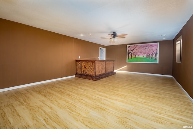 unfurnished room with ceiling fan and light hardwood / wood-style floors