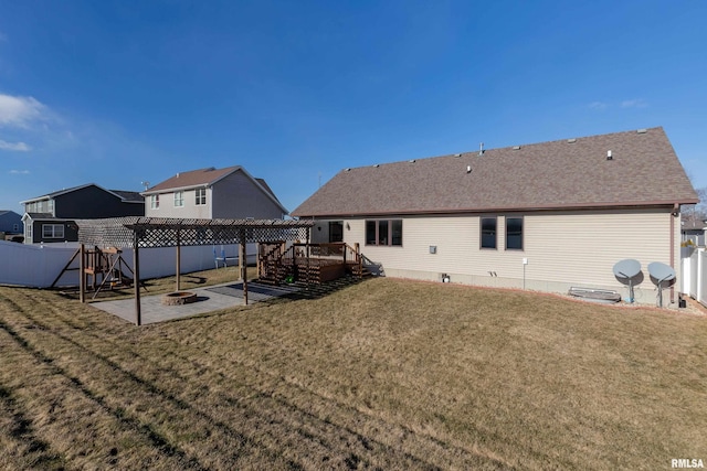 back of house featuring a pergola, a patio area, and a lawn