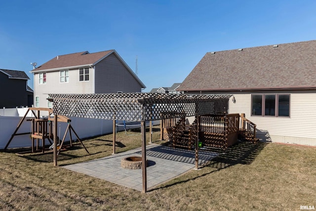 exterior space featuring a patio, a playground, an outdoor fire pit, and a lawn