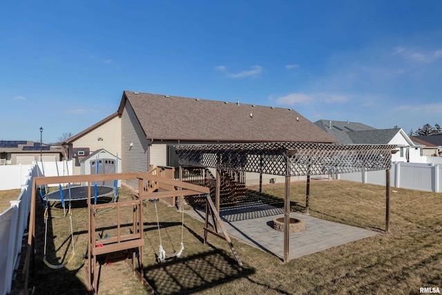 exterior space featuring a trampoline, a storage shed, a playground, and a patio