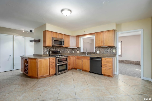 kitchen with stainless steel appliances, tasteful backsplash, sink, and light tile patterned floors