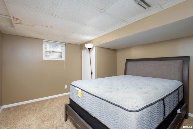 bedroom featuring a paneled ceiling and carpet floors